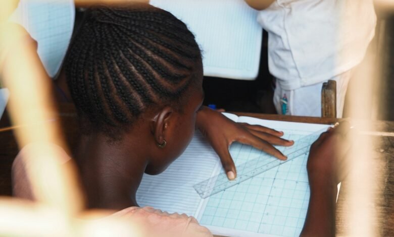 A schoolgirl working on a classroom exercise, illustrative photograph about girls' education and school safety